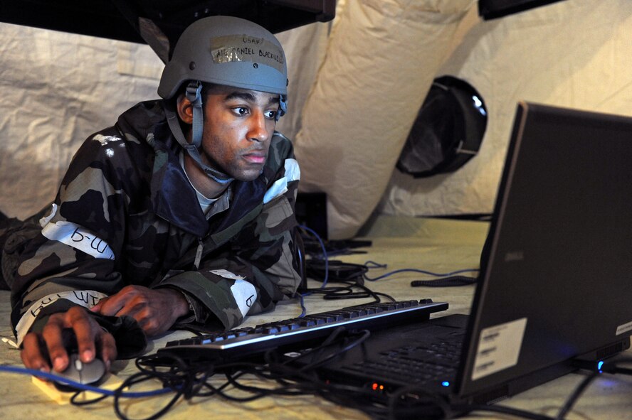 Airman 1st Class Daniel Blackwell, a 4th Fighter Wing public affairs specialist, works from cover during a simulated attack Feb. 5, 2014, at Seymour Johnson Air Force Base, N.C. The attack was part of an employment exercise used to test Airmen readiness for contingency operations overseas. (U.S. Air Force photo by Airman 1st Class Aaron J. Jenne)
