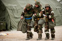 Airmen of the 4th Communications Squadron perform a two-man support carry after their wingman suffered an ankle injury during Employment Exercise Coronet Warrior 14-01, Feb. 4, 2014, at Seymour Johnson Air Force Base, N.C.  Exercise participants responded to random injects that tested their deployment skills.  (U.S. Air Force photo by Airman 1st Class Brittain Crolley)