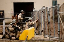 Defenders of the 4th Security Forces Squadron open an alternate entry control point (ECP) to an exercise play area during Employment Exercise Coronet Warrior 14-01, Feb. 4, 2014, at Seymour Johnson Air Force Base, N.C.  The defenders quickly opened a new ECP after a simulated attack destroyed the main entrance.  (U.S. Air Force photo by Airman 1st Class Brittain Crolley) 