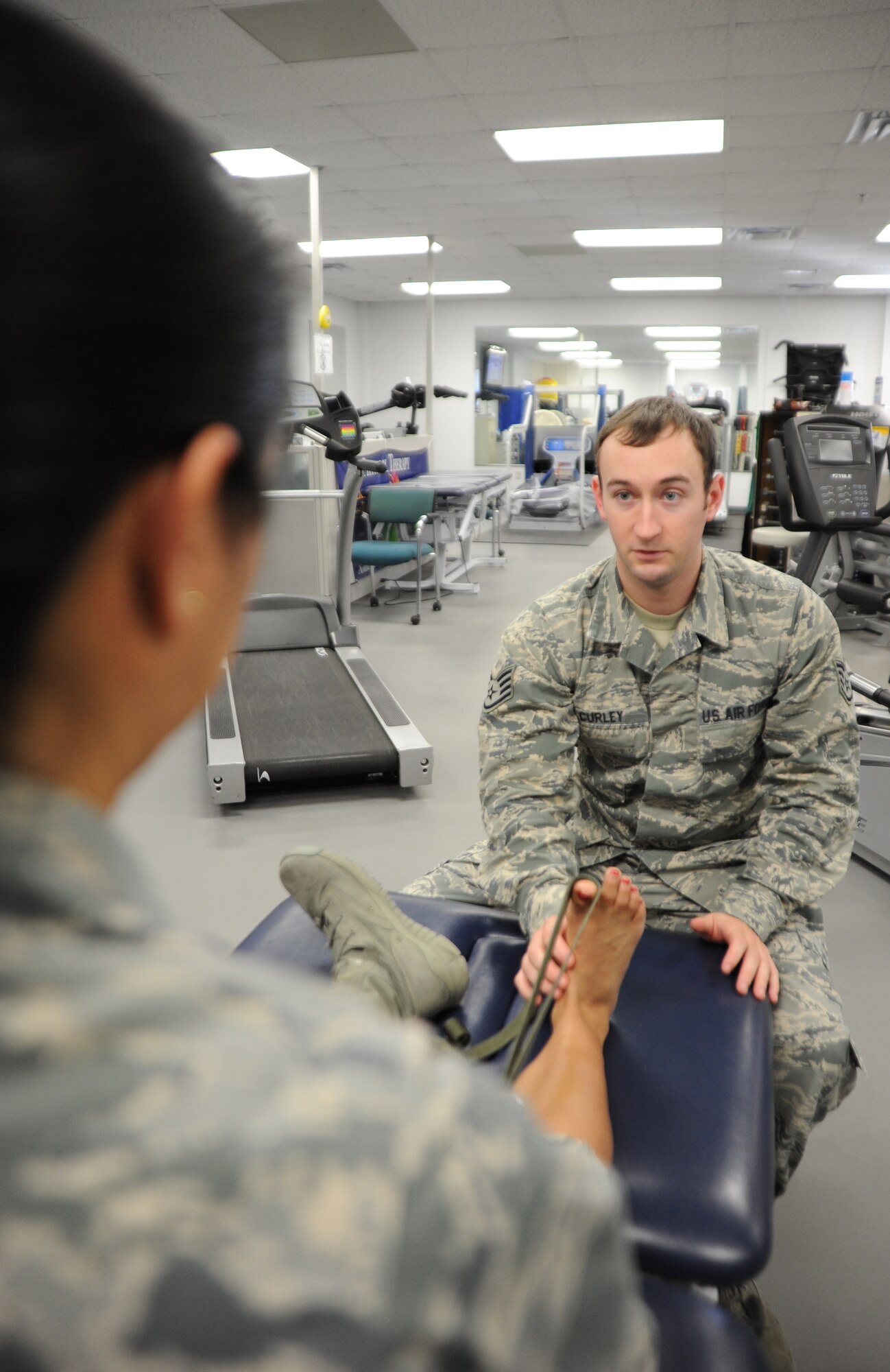 Staff Sgt. David Curley, 1st Special Operations Medical Operations Squadron NCO in charge of physical therapy, instructs Lt. Col. Marybeth Luna, 1st Special Operations Medical Support Squadron diagnostic and therapeutic flight commander, how to stretch a muscle in her foot at Hurlburt Field, Fla., Jan. 21, 2013. Physical therapist help members prevent injuries by providing instruction on proper stretching as well as rehabilitation after an injury or surgery. (U.S. Air Force photo/Staff Sgt. Victoria Sneed)