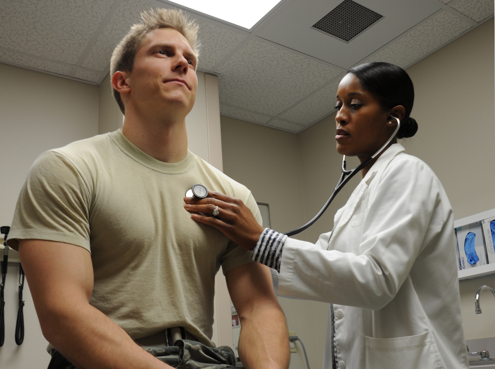 Anisa Mathis, 1st Special Operations Medical Operations Squadron physician’s assistant, listens to Senior Airman Ryan Starnowsky’s, 1st SOMDOS aerospace medical technician, heart at Hurlburt Field, Fla., Jan. 21, 2013. (U.S. Air Force photo/Staff Sgt. Victoria Sneed)
