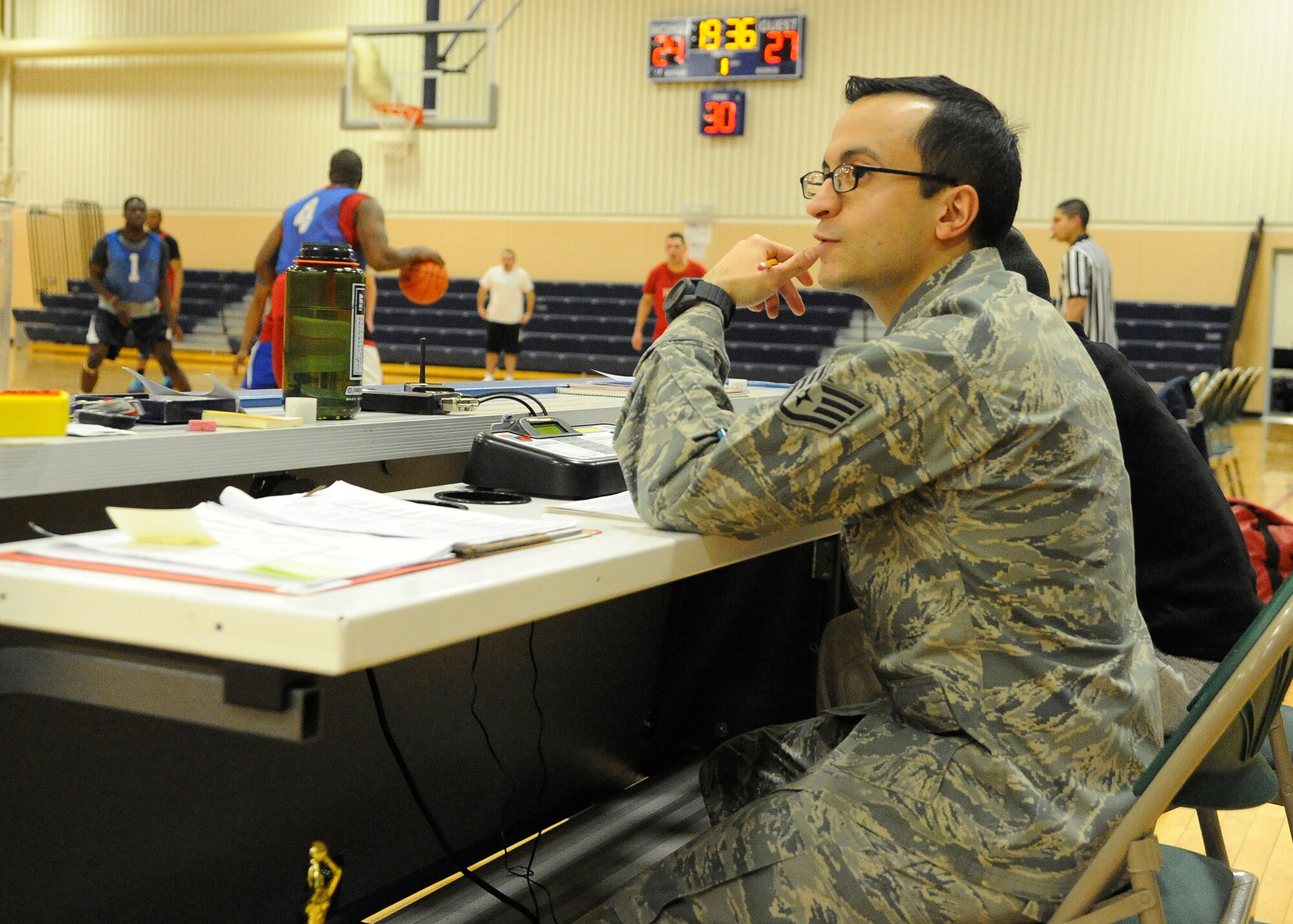 Staff Sgt. Josue Silva, 341st Force Support Squadron sports director, keeps score during the 2013 intramural basketball season championship game Feb. 3. Out of the 16 teams that started the 2013 season, eight made it to the playoffs. (U.S. Air Force photo/Airman 1st Class Collin Schmidt)