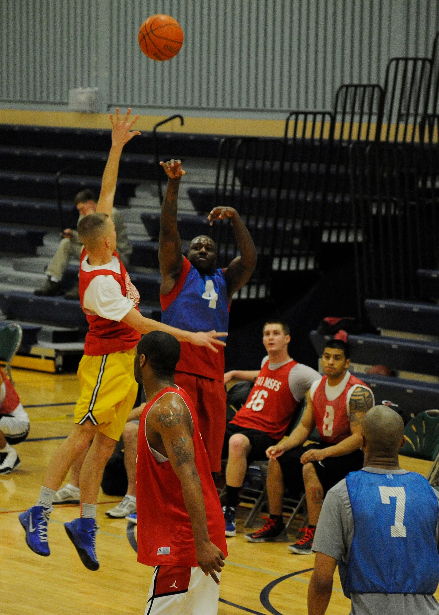 A member of the blue 341st Force Support Squadron team attempts a three point shot during the first half of Malmstrom’s 2013 intramural basketball season championship game Feb. 3. According to the fitness center staff, the Airmen who played this season have been some of the most talented and competitive they have seen in recent years. (U.S. Air Force photo/Airman 1st Class Collin Schmidt)