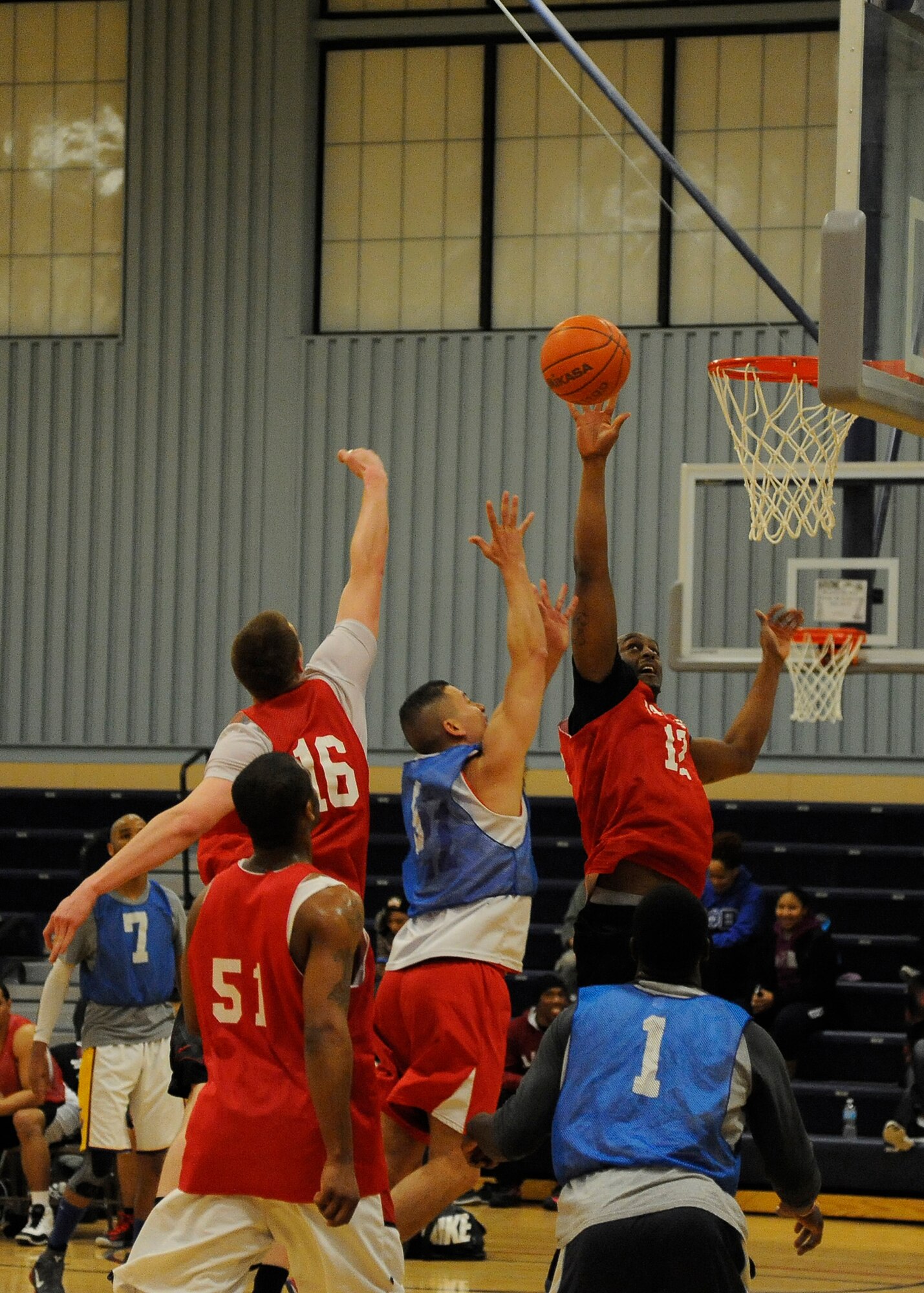 A member of the red 741st Missile Security Forces Squadron team blocks a layup attempt during the second half of the 2013 intramural basketball season championship game Feb. 3. The block forced a turnover and allowed the 741st MSFS team to gain a four-point lead. (U.S. Air Force photo/Airman 1st Class Collin Schmidt)