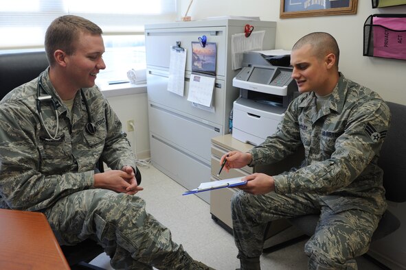 Senior Airman Casey Blakeley, 341st Medical Operations Squadron Family Health Clinic medical technician (right) gives Capt. Trevor Peterson, 341st MDOS Family Health Clinic staff physician, a patient history before an appointment at the Malmstrom Air Force Base Clinic on Jan. 28. The family health clinic has three physicians, two physician assistants, two nurses and 12 active-duty medical technicians. (U.S. Air Force photo/Senior Airman Katrina Heikkinen)