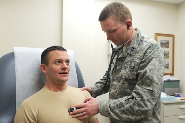 Staff Sgt. Michael Canfield, 341st Medical Operations Squadron Family Health Clinic medical technician (left) sits still as Capt. Trevor Peterson, 341st MDOS Family Health Clinic staff physician, listens to his heart rate during a routine exam at the Malmstrom Air Force Base Clinic on Jan. 28. The family health clinic sees all beneficiaries from Malmstrom including active-duty Airmen, dependents and retirees. (U.S. Air Force photo/Senior Airman Katrina Heikkinen)