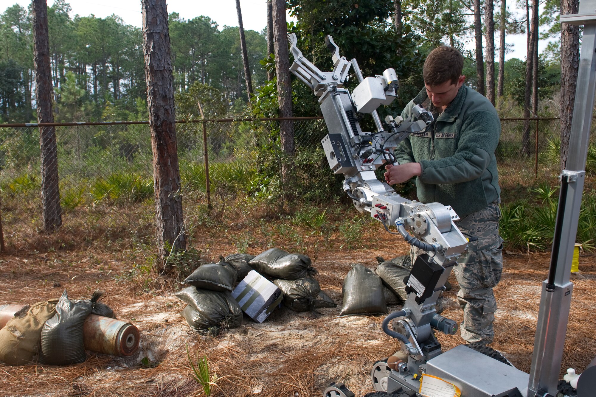 An Airman with the 1st Special Operations Civil Engineer Squadron explosive ordnance disposal adjusts an F-6 robot during training at Hurlburt Field, Fla., Feb. 6, 2014.  The robot served as a reconnaissance and positive action tool, which EOD technicians use in real-world and training scenarios. (U.S. Air Force photo/Senior Airman Naomi Griego) 