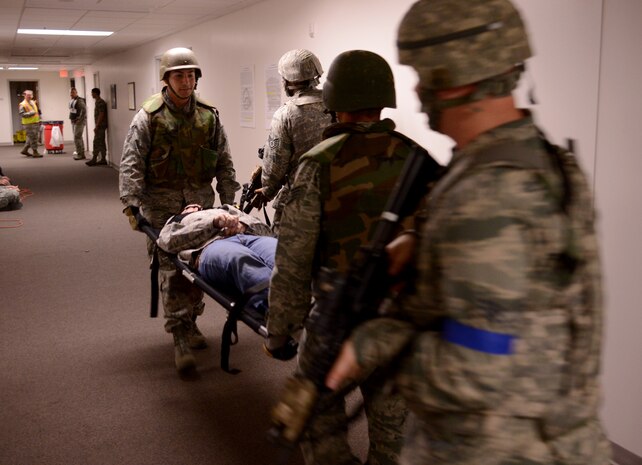 Members of 9th Security Forces and 9th Medical Squadron transport a simulated victim during an active shooter exercise at Beale Air Force Base, Calif., Feb. 5, 2014. Simulated victims were added to the scenario to a sense of realism. (U.S. Air Force photo by Tech. Sgt. Ricky Bloom/Released)