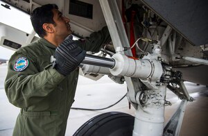 Warrant Officer Bavvr Al-Duwaisan, Kuwait Air Force’s 41st Transport Squadron loadmaster, performs initial checks prior to take-off Feb. 5, 2014, on a C-17 Globemaster III at Joint Base Charleston – Air Base, S.C. The Kuwait Air Force recently purchased a second C-17 and 17th AS Airmen were to familiarize the Kuwait flight crew on the operations and maintenance of the C-17. (U.S. Air Force photo/ Airman 1st Class Clayton Cupit)