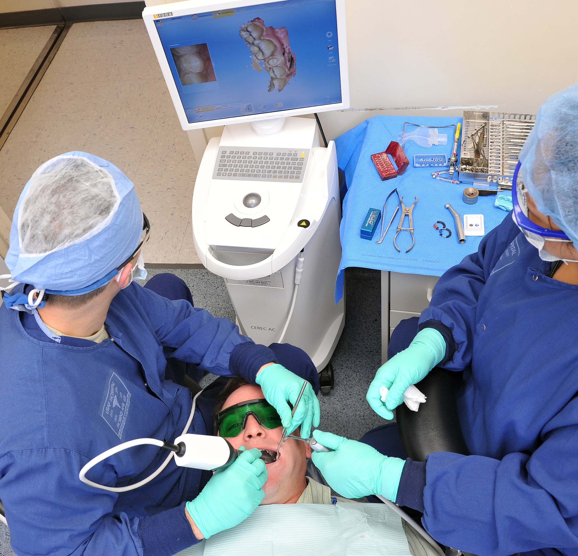 Capt. Ben Areheart, 78th Dental Squadron, dentist, and Suzette Shoulta, dental assistant, use a digital scanner to produce a three dimensional image of a patient’s teeth and soft tissue structures. (U.S. Air Force photo by Tommie Horton)