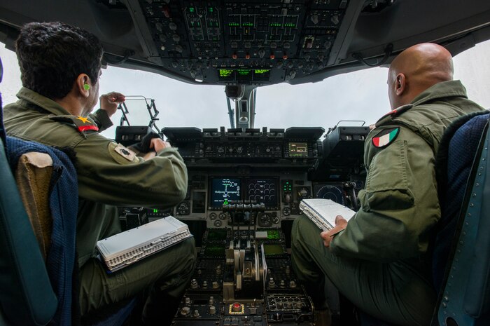 Lt. Col. Abdulaziz Al-Loghani (left) and Lt. Col. Khaled Al-Shami, both pilots from the Kuwait Air Force’s 41st Transport Squadron, perform initial checks prior to take-off Feb. 5, 2014, on a C-17 Globemaster III at Joint Base Charleston – Air Base, S.C. The Kuwait Air Force recently purchased a second C-17 and 17th AS Airmen were to familiarize the Kuwait flight crew on the operations and maintenance of the C-17. (U.S. Air Force photo/ Airman 1st Class Clayton Cupit)