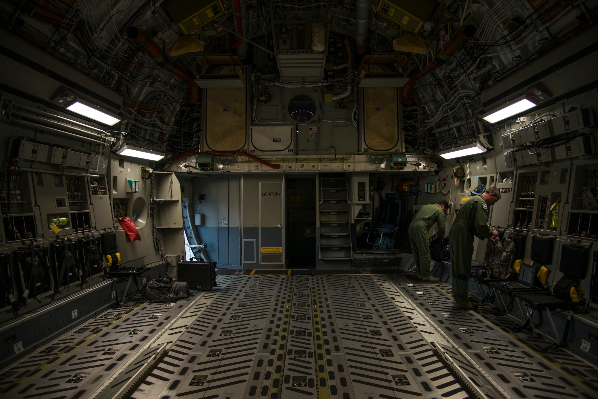 Warrant Officer Bavvr Al-Duwaisan (left), Kuwait Air Force’s 41st Transport Squadron loadmaster, and Tech. Sgt. Joe York, 17th Airlift Squadron noncommissioned officer in charge in charge of standards and evaluations, prepare their equipment prior to take-off Feb. 5, 2014, on a C-17 Globemaster III at Joint Base Charleston – Air Base, S.C. The Kuwait Air Force recently purchased a second C-17 and 17th AS Airmen were to familiarize the Kuwait flight crew on the operations and maintenance of the C-17. (U.S. Air Force photo/ Airman 1st Class Clayton Cupit)