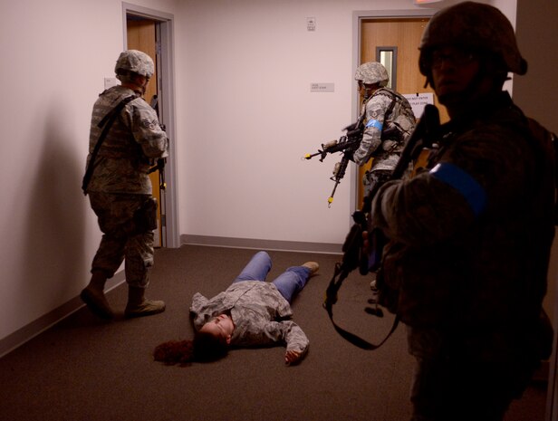 9th Security Forces members secure a building during an active shooter exercise at Beale Air Force Base, Calif., Feb. 5, 2014. Simulated victims were added to the scenario to create a sense of realism. (U.S. Air Force photo by Tech. Sgt. Ricky Bloom/Released)