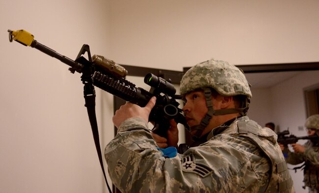 A 9th Security Forces member clears a room during an active shooter exercise at Beale Air Force Base, Calif., Feb. 5, 2014. Security Forces members utilized blank rounds to create a sense of realism. (U.S. Air Force photo by Tech. Sgt. Ricky Bloom/Released)