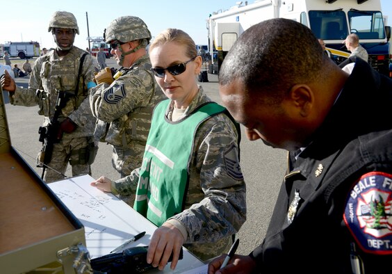 Master Sgt. Gina Ennis, 9th Civil Engineering Squadron, assistant chief of operations, participates as the incident commander during an active shooter exercise at Beale Air Force Base, Calif., Feb. 5, 2014. Local and county law enforcement also participated in the exercise. (U.S. Air Force photo by John Schwab/Released)