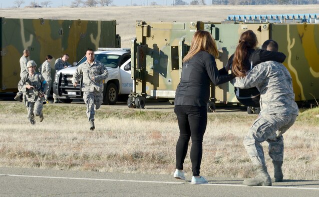 Beale first responders aid a simulated victim during an active shooter exercise at Beale Air Force Base, Calif., Feb. 5, 2014. Simulated victims were added to the scenario to create a sense of realism. (U.S. Air Force photo by John Schwab/Released)