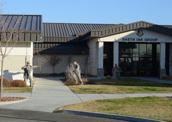 Members of the 548th Intelligence, Surveillance, and Reconnaissance Group, evacuate their building during an active shooter exercise at Beale Air Force Base, Calif., Feb. 5, 2014. Simulated victims were added to the scenario to create a sense of realism. (U.S. Air Force photo by John Schwab/Released)