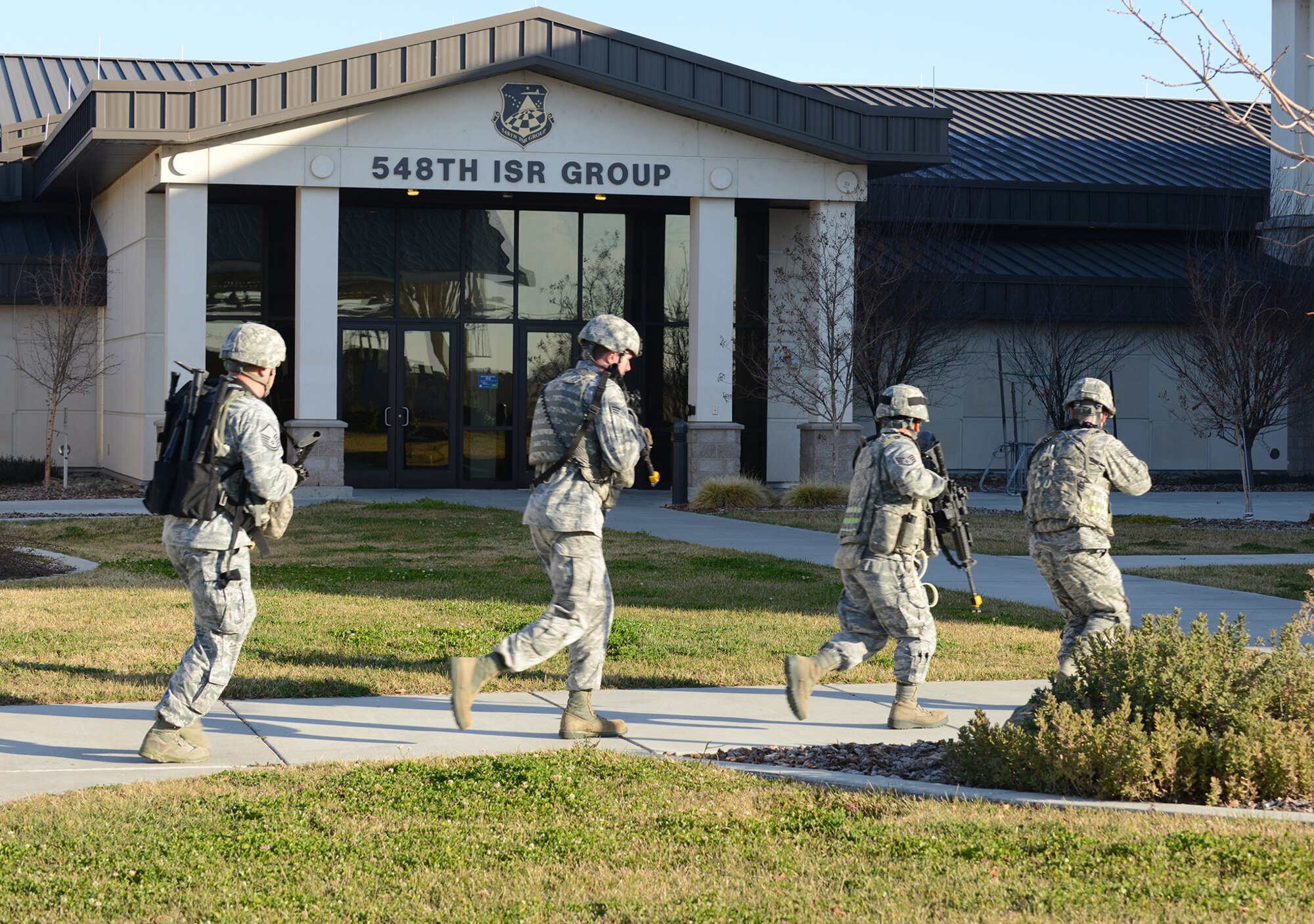 9th Security Forces members respond to an active shooter exercise at the 548th Intelligence, Surveillance, and Reconnaissance Group building on Beale Air Force Base, Calif., Feb. 5, 2014. SF utilize breach equipment to gain access to barricaded and locked doors. (U.S. Air Force photo by John Schwab/Released)