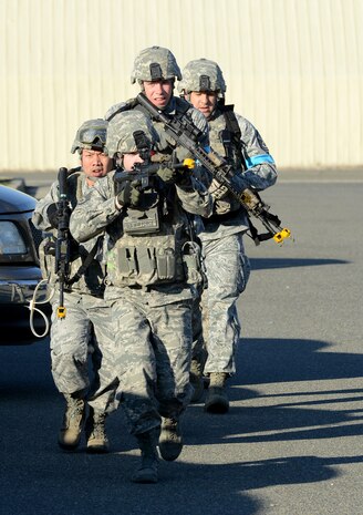 Staff Sgt. James Grueser, 9th Security Forces Squadron, leads a team of defenders during an active shooter exercise at Beale Air Force Base, Calif., Feb. 5, 2014. Security Forces utilize the M-4 Carbine to combat close to medium range threats.  (U.S. Air Force photo by John Schwab/Released)