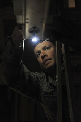 U.S. Air Force Tech. Sgt. Nathan Wesley, 393rd Aircraft Maintenance Unit crew 1 weapons load crew member, “sways the bomb” during the 2013 Load Competition of the Year. Loaders use sway pads to secure the bomb in the aircraft to prevent it from coming loose or falling out during the loading process. (U.S. Air Force photo by Airman 1st Class Keenan Berry/Released)