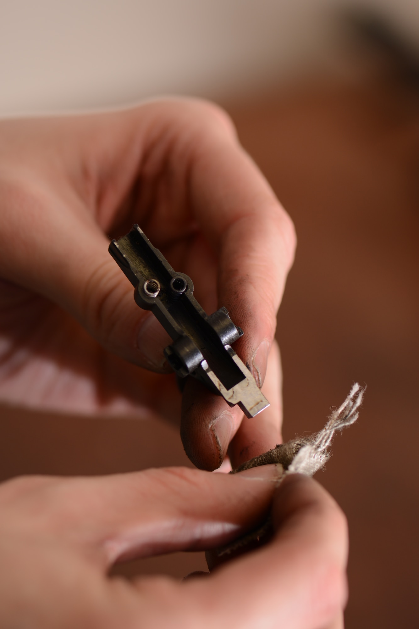 U.S. Air Force Airman 1st Class Joey Long, 100th Security Forces Squadron armory journeyman from Overland Park, Kan., cleans the trigger of an M4 carbine Jan. 30, 2014, on RAF Mildenhall, England. Regular weapons maintenance is essential in ensuring they function correctly. Armorers perform upkeep on weapons and distribute them to security forces personnel during shift changes.  (U.S. Air Force photo by Airman 1st Class Dillon Johnston/Released)