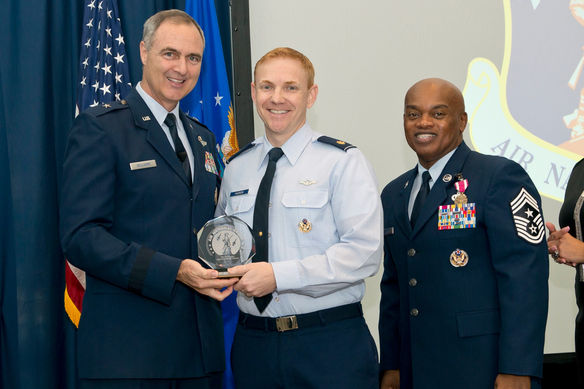 Brig. Gen. R. Scott Williams, the commander of the Air National Guard Readiness Center, and Chief Master Sgt. Tony L. Whitehead, the command chief master sergeant of the ANGRC, present the Field Grade Officer of the Quarter to Maj. James W. Hudson, ANGRC Air, Space and Information Operations, during the ANGRC 4th Quarter Awards Ceremony and Commander’s Call Feb. 6, 2014, at the ANGRC, Joint Base Andrews, Md. The ceremony hosted by Williams recognizes the accomplishments of the ANGRC staff. (U.S. Air National Guard photo by Master Sgt. Marvin R. Preston/RELEASED)