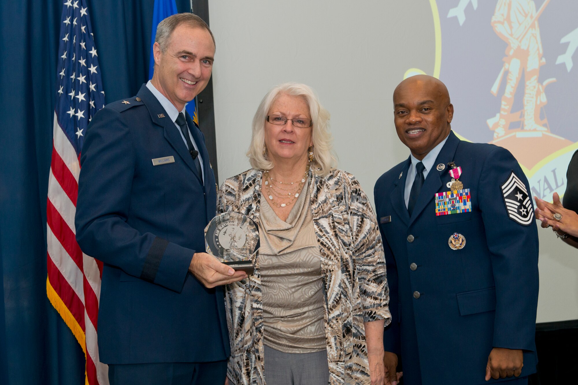 Brig. Gen. R. Scott Williams, the commander of the Air National Guard Readiness Center, and Chief Master Sgt. Tony L. Whitehead, the command chief master sergeant of the ANGRC, present the Civilian of the Quarter Category 3 award to Cathy S. Rico, ANGRC Air, Space and Information Operations, during the ANGRC 4th Quarter Awards Ceremony and Commander’s Call Feb. 6, 2014, at the ANGRC, Joint Base Andrews, Md. The ceremony hosted by Williams recognizes the accomplishments of the ANGRC staff. (U.S. Air National Guard photo by Master Sgt. Marvin R. Preston/RELEASED)