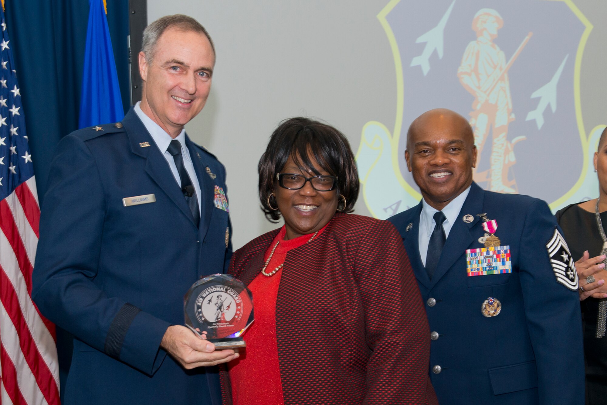 Brig. Gen. R. Scott Williams, the commander of the Air National Guard Readiness Center, and Chief Master Sgt. Tony L. Whitehead, the command chief master sergeant of the ANGRC, present the Civilian of the Quarter Category 2 award to Judy G. Rodgers, ANGRC Operational Support and Compliance, during the ANGRC 4th Quarter Awards Ceremony and Commander’s Call Feb. 6, 2014, at the ANGRC, Joint Base Andrews, Md. The ceremony hosted by Williams recognizes the accomplishments of the ANGRC staff. (U.S. Air National Guard photo by Master Sgt. Marvin R. Preston/RELEASED)