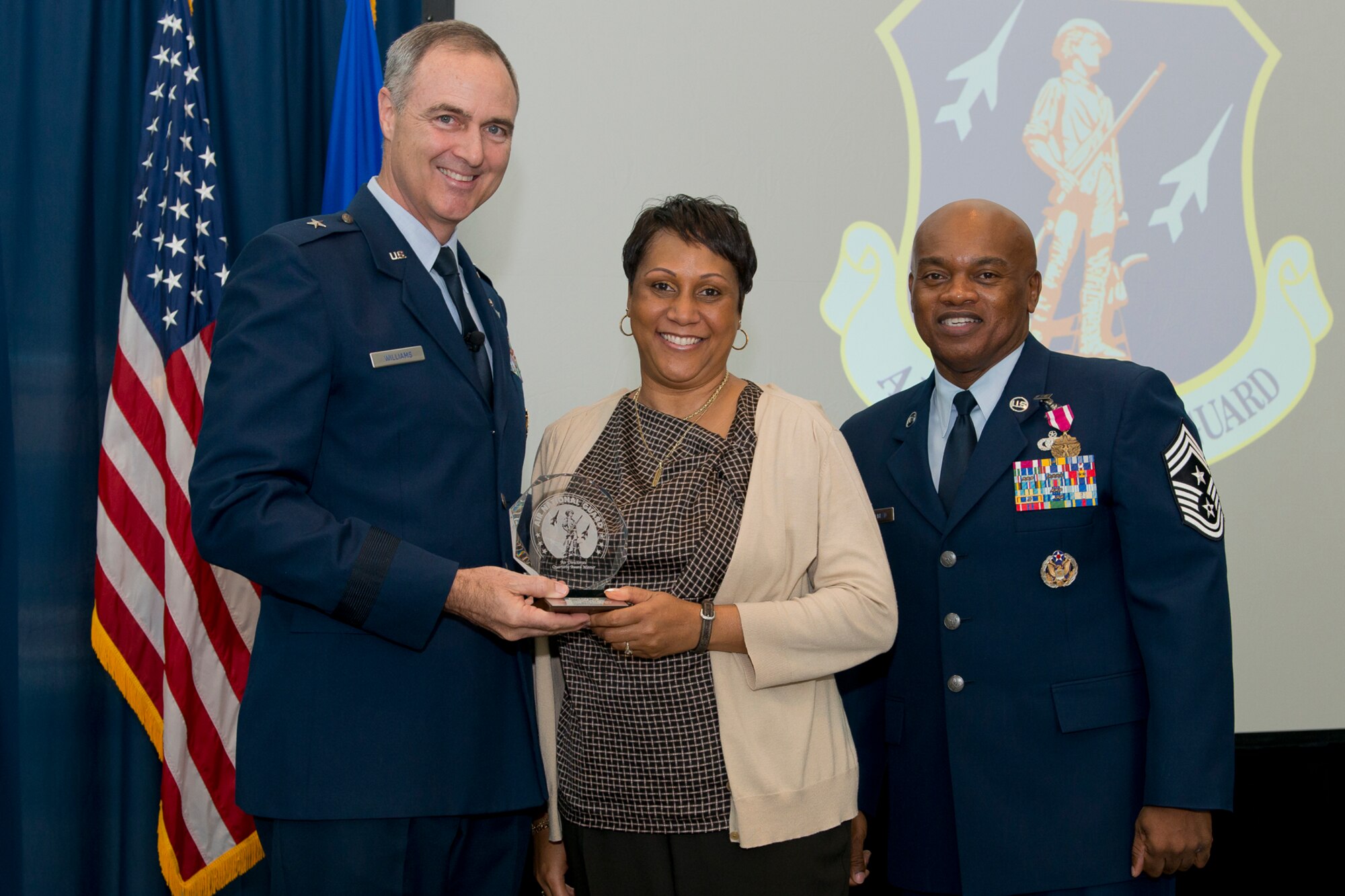 Brig. Gen. R. Scott Williams, the commander of the Air National Guard Readiness Center, and Chief Master Sgt. Tony L. Whitehead, the command chief master sergeant of the ANGRC, present the Civilian of the Quarter Category 1 award to Sharnea Craig-Woods, ANGRC Logistics, during the ANGRC 4th Quarter Awards Ceremony and Commander’s Call Feb. 6, 2014, at the ANGRC, Joint Base Andrews, Md. The ceremony hosted by Williams recognizes the accomplishments of the ANGRC staff. (U.S. Air National Guard photo by Master Sgt. Marvin R. Preston/RELEASED)