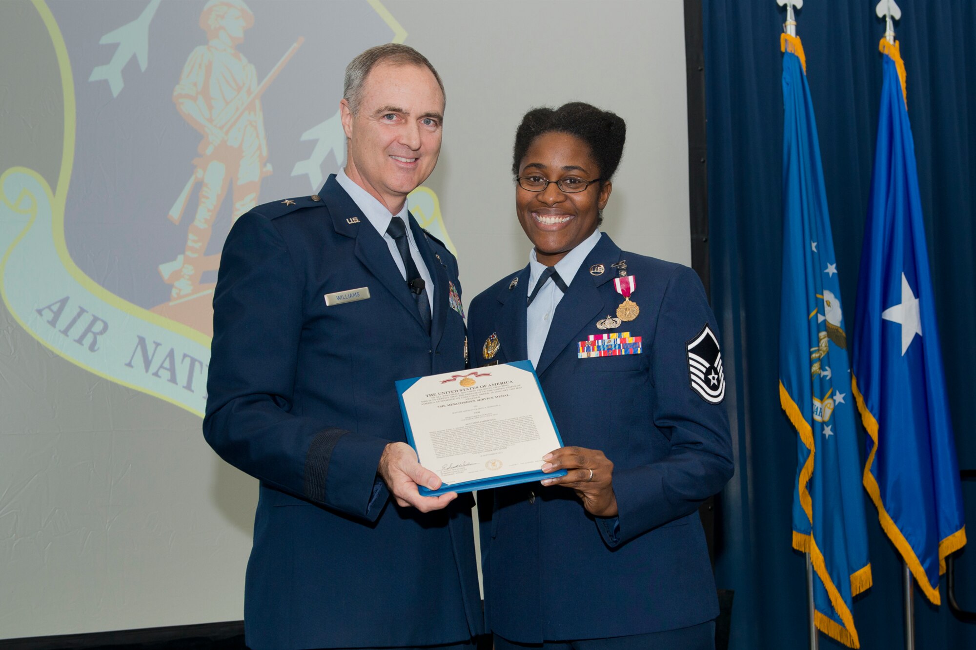 Brig. Gen. R. Scott Williams, the commander of the Air National Guard Readiness Center, presents the Meritorious Service Medal to Master Sgt. Karen A. Marshall during the ANGRC 4th Quarter Awards Ceremony and Commander’s Call Feb. 6, 2014, at the ANGRC, Joint Base Andrews, Md. Marshall worked as the ANG Recruiting and Retention Creative Advisor from Oct. 1, 2009 to July 31, 2012 where she created the first complete return on investment for the military marketing program that enabled investments to be compared with industry standards, creating a transparent $18 million program.