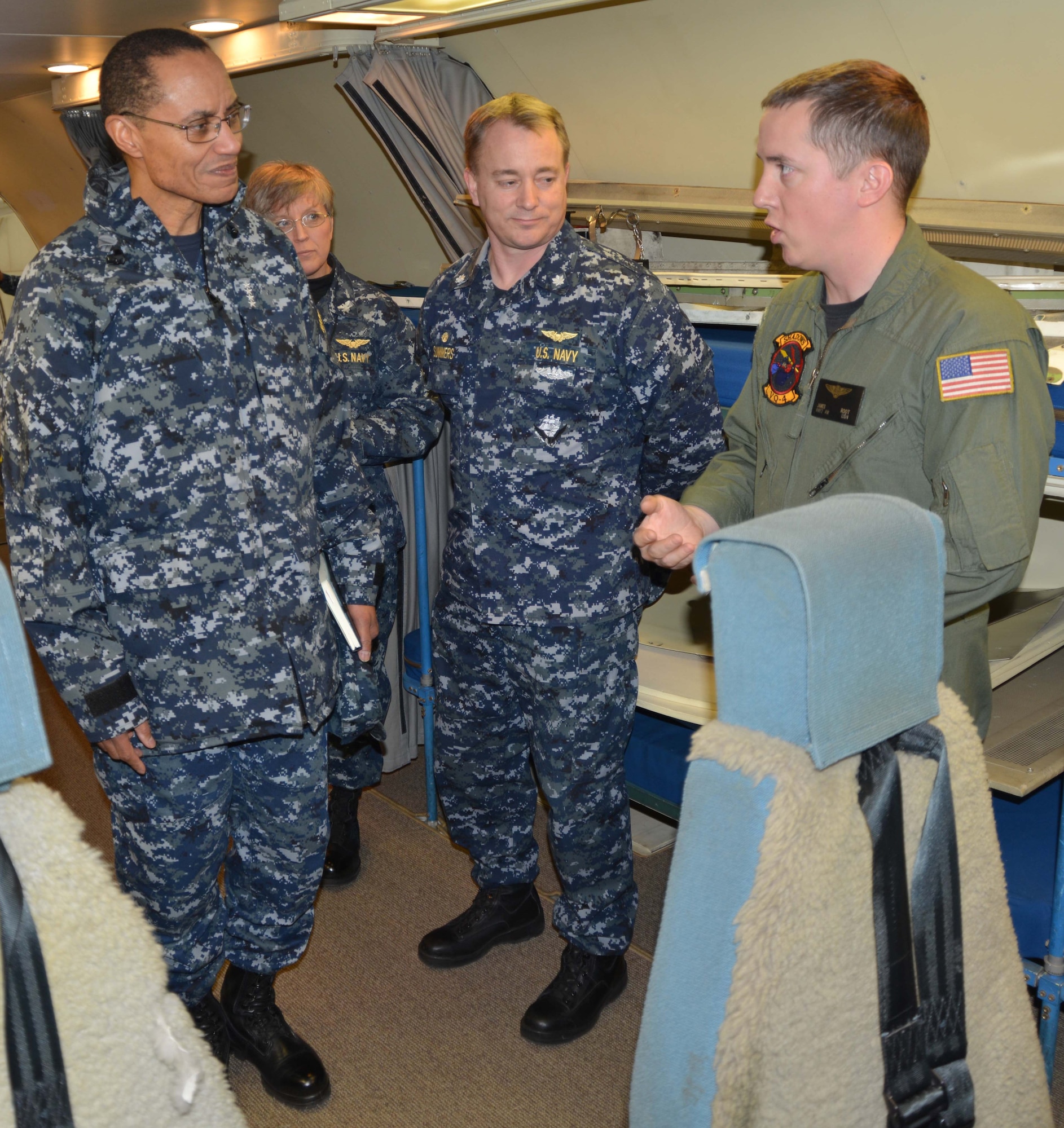 U.S. Navy photo by Chief Mass Communication Specialist Chris Delano
Aircrewman Mechanical 2nd Class James Root, right, relates the abilities of the Navy’s E6B Mercury aircraft to Adm. Cecil Haney, left, commander of U.S. Strategic Command. Also present during the briefing were Capt. Heather Cole, commander of Strategic Communications Wing 1 and Task Force 124, and Commander Jeff Summers, the Fleet Air Reconnaissance Squadron 4 Skipper. The admiral visited several TACAMO facilities while on his Jan. 24 trip, including VQ-4. During his visit to Tinker AFB, the admiral thanked the Sailors throughout Strategic Communications Wing 1 and stressed the importance of their contributions to the nation’s nuclear deterrence mission. (U.S. Navy photo by Chief Mass Communication Specialist Chris Delano)