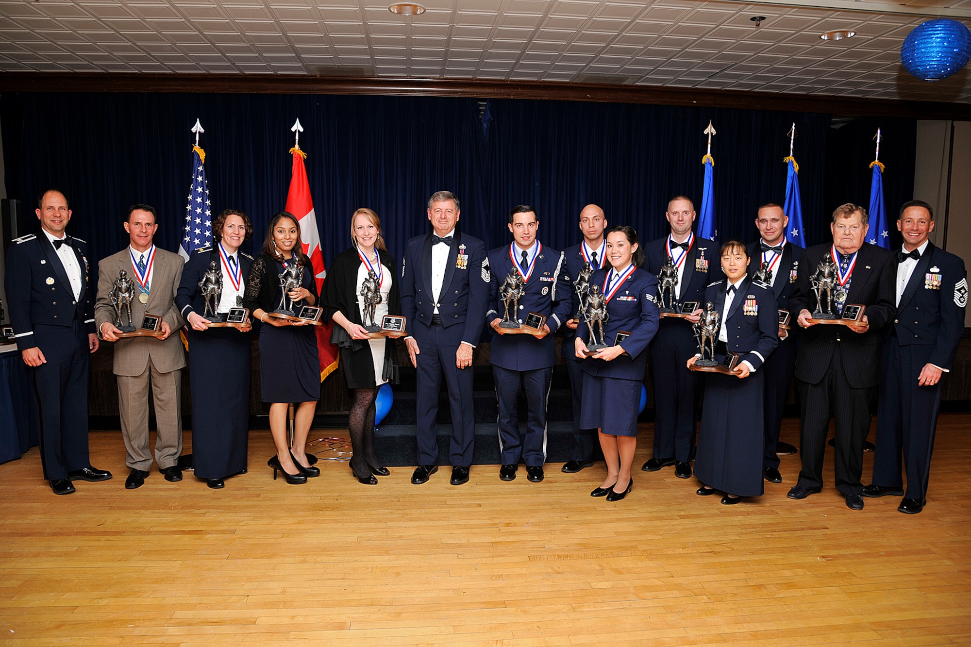 PETERSON AIR FORCE BASE, Colo. – Awardees from the 2013 annual awards ceremony pose for a photo with Col. John Shaw, 21st Space Wing commander (far left), 11th Chief Master Sgt. of the Air Force David Campanale (middle), and Chief Master Sgt. Richard Redman, 21st Space Wing command chief (far right). The 21st SW held its annual awards dinner Jan. 28 at The Club. These awardees represent the very best in leadership and professionalism within the 21st SW. (U.S. Air Force photo/Dennis Howk)