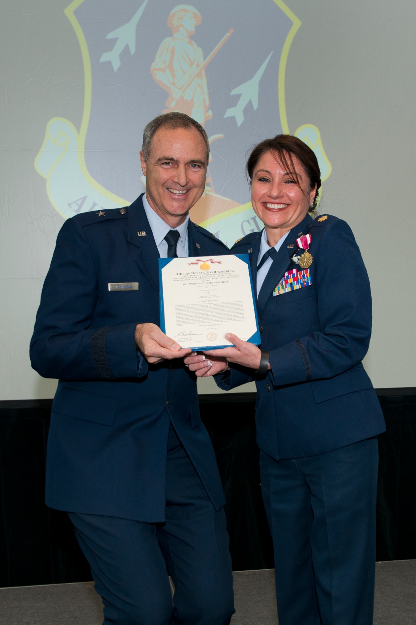 Brig. Gen. R. Scott Williams, the commander of the Air National Guard Readiness Center, presents the Meritorious Service Medal, first Oak Leaf Cluster, to Maj. Dianna M. Lebedev during the ANGRC 4th Quarter Awards Ceremony and Commander’s Call Feb. 6, 2014, at the ANGRC, Joint Base Andrews, Md. Lebedev received the MSM, first Oak Leaf Cluster, because of her work as the Information Operations Area Functional Manager in the Air, Space and Information Operations Directorate from Oct. 1, 2011, to Aug. 4, 2014, developing the first ever ANG standardized cyber red team to perform a unique operational mission covered by no other source.