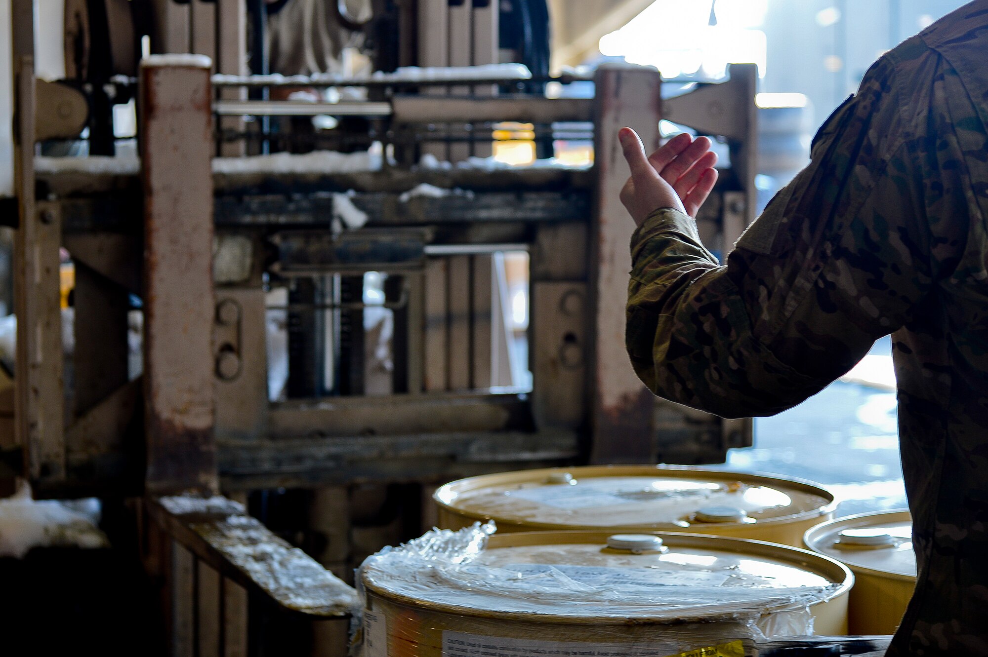 A U.S. Air Force Airman assigned to the 455th Expeditionary Logistics Readiness Squadron acts as a spotter for a forklift at Bagram Airfield, Afghanistan, Feb. 7, 2014. The vehicle maintenance shop is responsible for maintaining and repairing vehicles that are vital to the mission at Bagram. (U.S. Air Force photo by Senior Airman Kayla Newman/Released)
