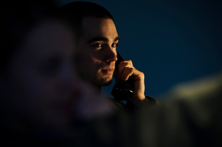Capt. Robert Shannon, 341st Operations Support Squadron missile combat crew commander, and Capt. Brooke Lake, 341st  OSS missile combat crew commander instructor, go through a launch procedure checklist during simulation training at Malmstrom Air Force Base, Mont., Feb. 6, 2014. The 341st OSS trains missile crews, missile alert facility managers and chefs to ensure they are proficient and combat ready. (U.S. Air Force photo by Staff Sgt. Jonathan Snyder/RELEASED)