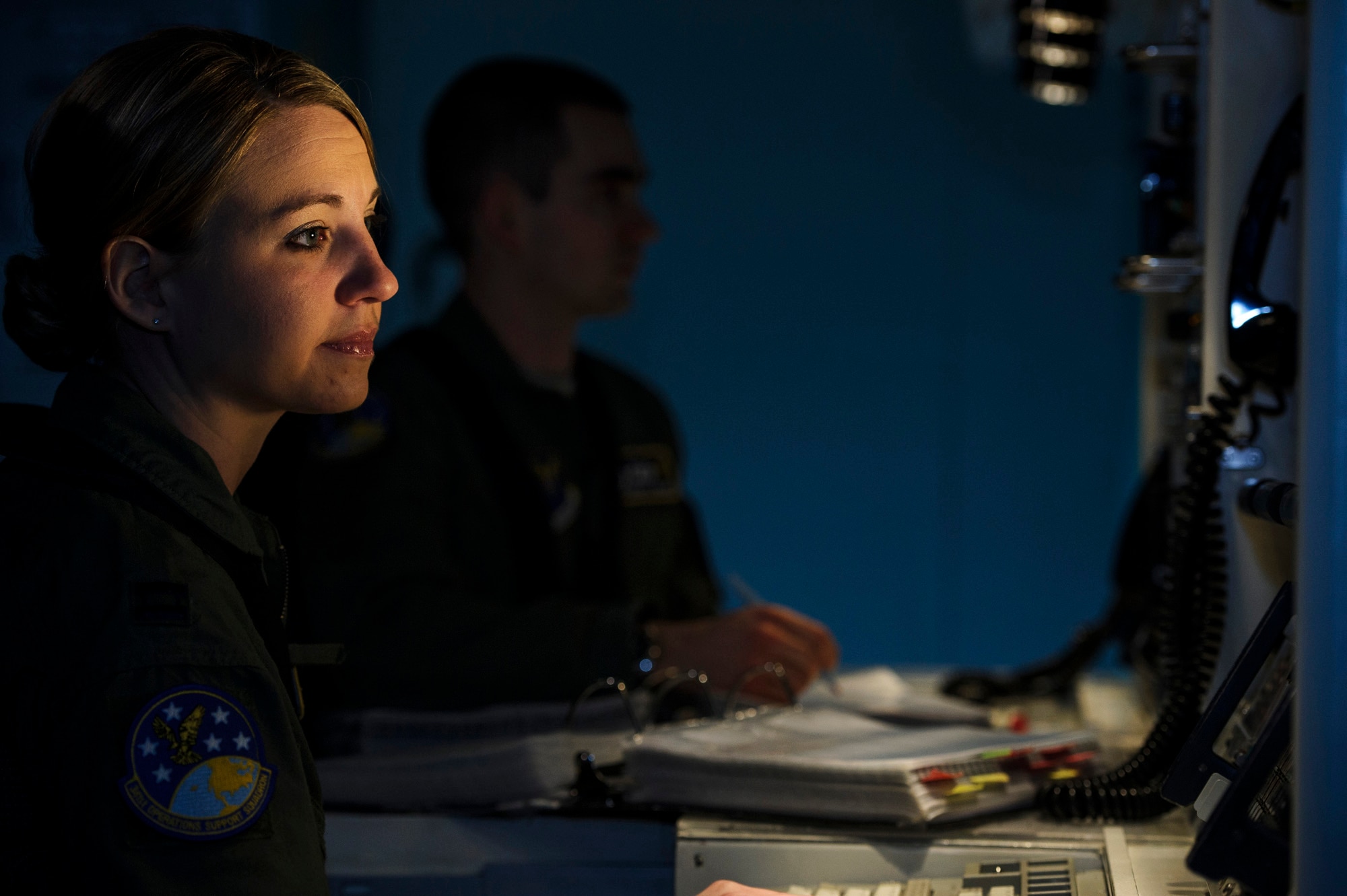Capt. Robert Shannon, 341st Operations Support Squadron missile combat crew commander, and Capt. Brooke Lake, 341st  OSS missile combat crew commander instructor, go through a launch procedure checklist during simulation training at Malmstrom Air Force Base, Mont., Feb. 6, 2014. The 341st OSS trains missile crews, missile alert facility managers and chefs to ensure they are proficient and combat ready. (U.S. Air Force photo by Staff Sgt. Jonathan Snyder/RELEASED)
