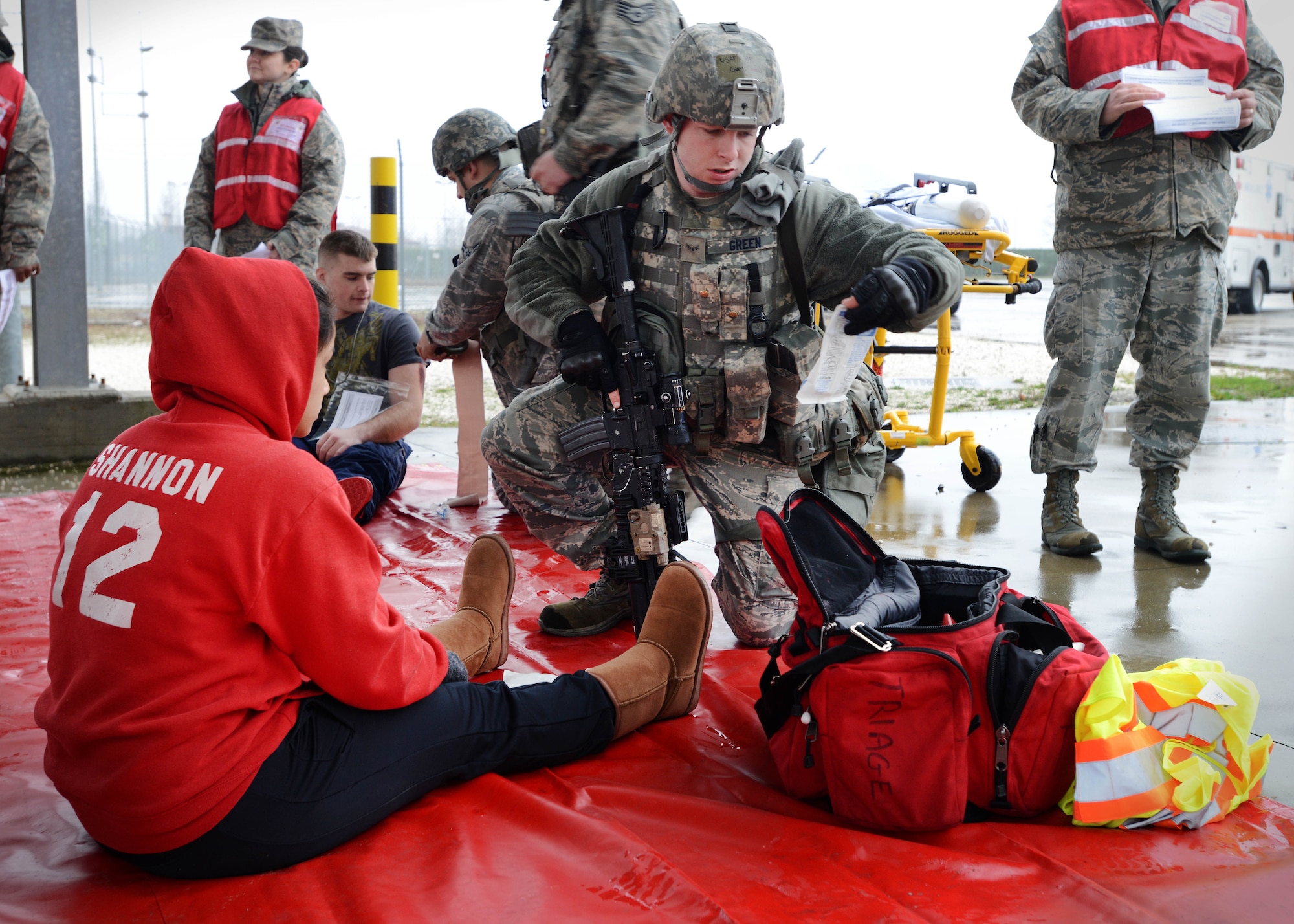 Airman 1st Class Deric Green, 31st Security Forces Squadron member, assists a simulated victim during a wing inspection, Feb. 5, 2014, at Aviano Air Base, Italy. Emergency responders participated in several simulated scenarios during a week-long inspection, which tested the wing’s ability to respond to emergency situations.  (U.S. Air Force photo/Airman 1st Class Deana Heitzman)
