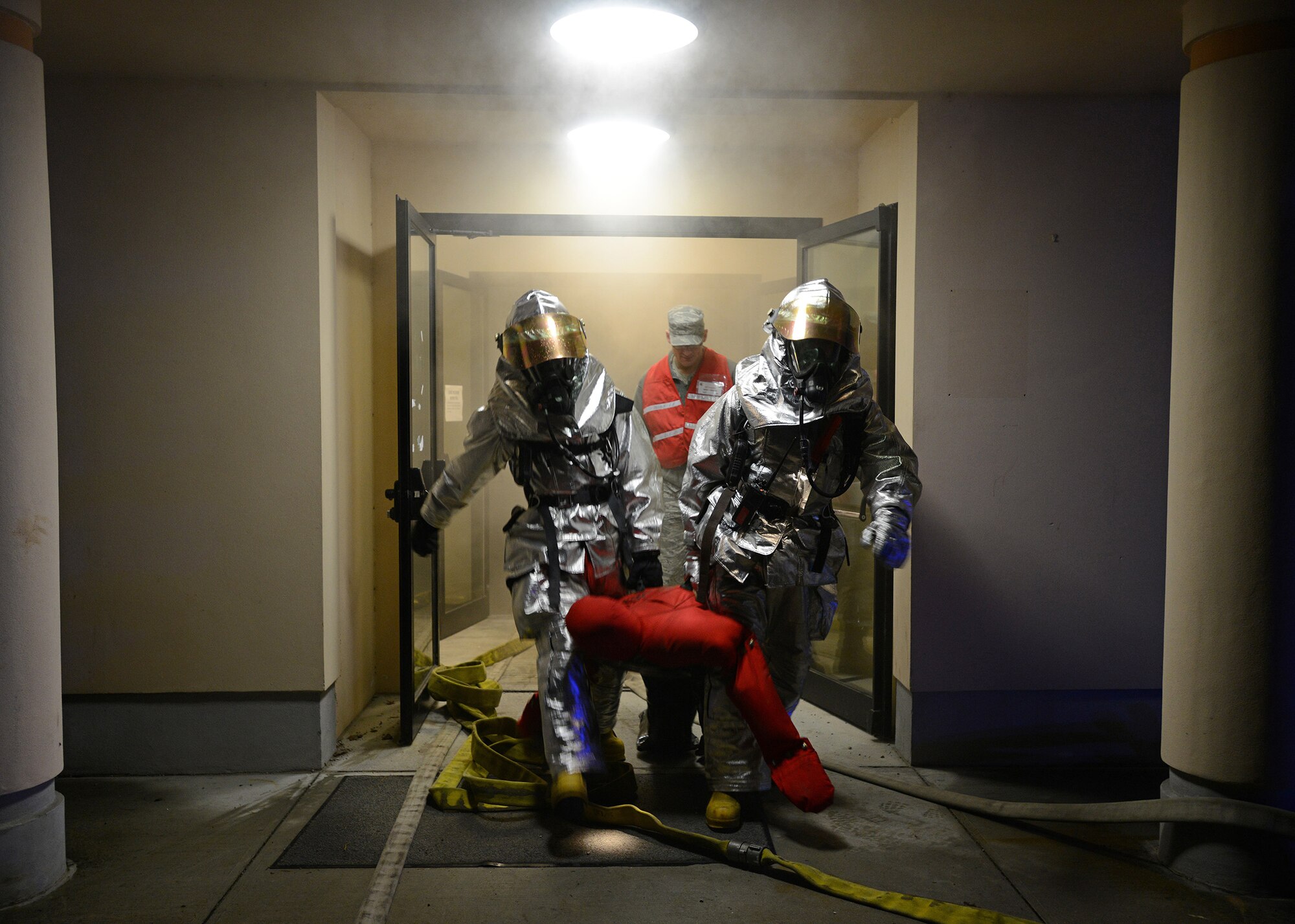Staff Sgt. Joseph Horocofsky and Senior Airman Michael Ford, 31st Civil Engineer Squadron firefighters, rescue a victim from a simulated fire, Feb. 3, 2014, at Aviano Air Base, Italy. The rescue was part of a wing inspection scenario to test fire and medical services’ ability to respond to an emergency situation. (U.S. Air Force photo/Staff Sgt. R.J. Biermann)