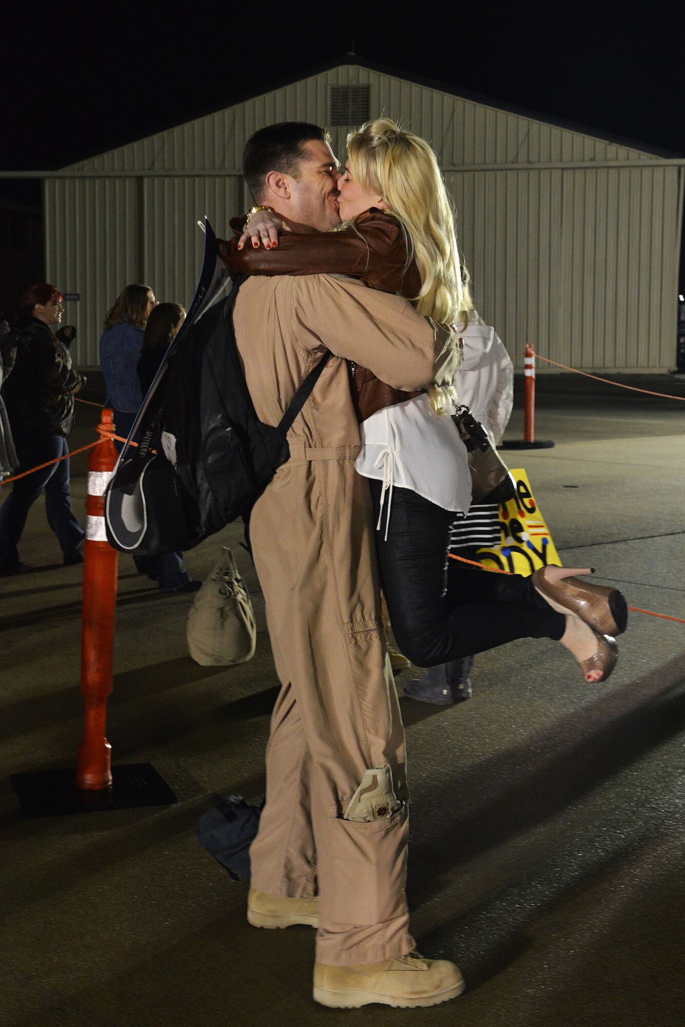 U.S. Air Force Maj. Ryan Miller, 79th Fighter Squadron F-16 Fighting Falcon pilot, embraces his wife Jaime, after returning to Shaw Air Force Base, S.C., from a deployment, Feb. 7, 2014. Miller, along with approximately 200 Shaw Airmen returned home from U.S. Central Command’s Area of Responsibility after five months of being away from their family and friends. (U.S. Air Force photo by Airman 1st Class Jensen Stidham/Released)