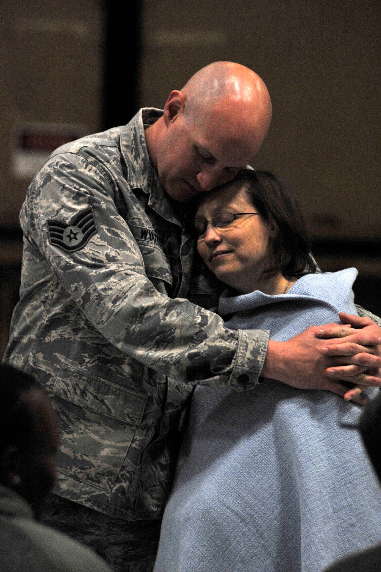 U.S. Air Force Staff Sgt. Scott Wyatt 20th Aerospace Medical Squadron independent duty medical technician, embraces his wife Joan, after returning to Shaw Air Force Base, S.C., from a deployment, Feb. 7, 2014. Wyatt, along with approximately 200 Shaw Airmen returned home from U.S. Central Command’s Area of Responsibility after five months of being away from their family and friends. (U.S. Air Force photo by Airman 1st Class Jensen Stidham/Released)