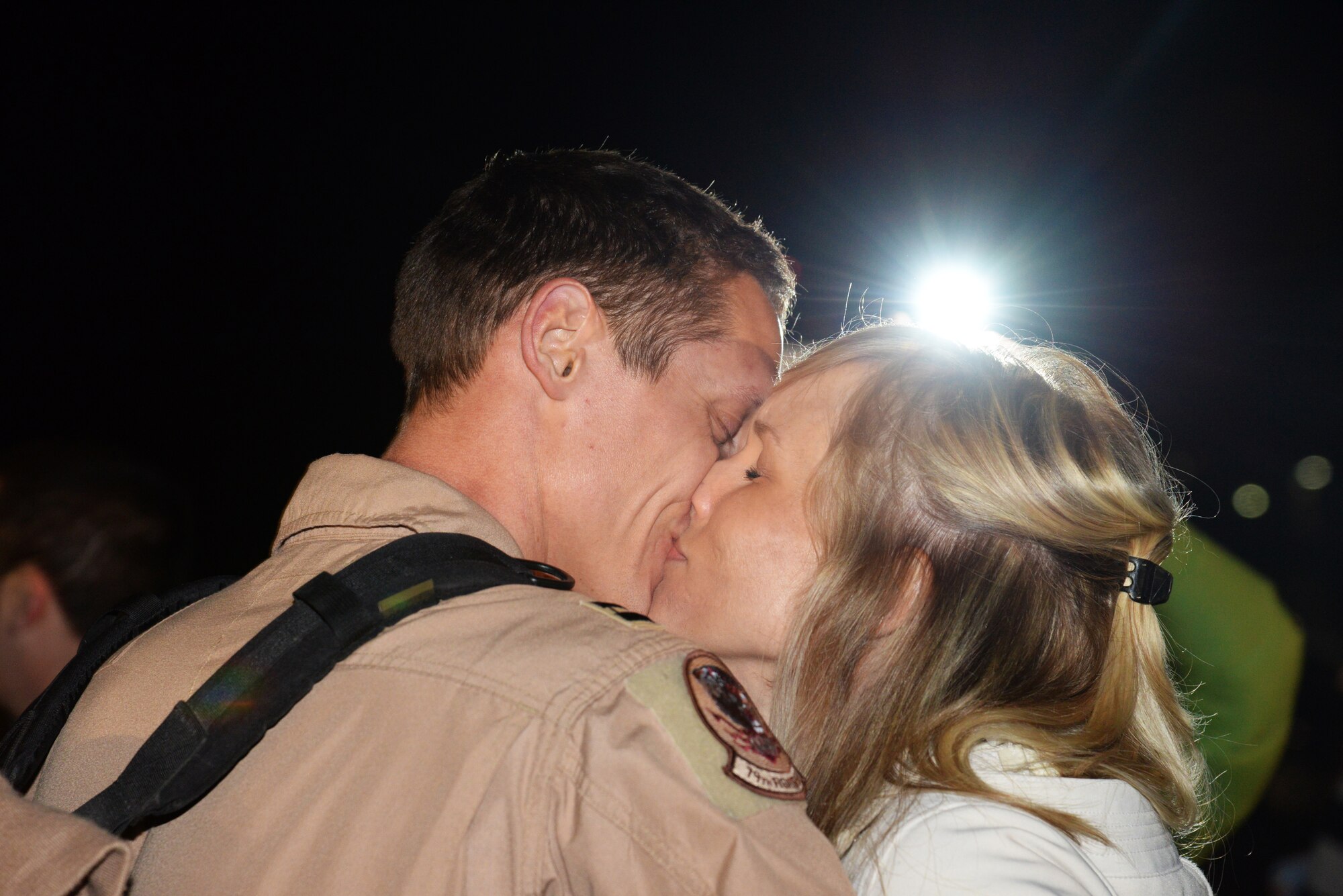 U.S. Air Force Capt. Craig Baker, 79th Fighter Squadron F-16 Fighting Falcon pilot, kisses his wife Lindsey Baker, after returning to Shaw Air Force Base, S.C., from a five-month deployment to U.S. Central Command’s Area of Responsibility, Feb. 7, 2014. Baker, along with approximately 200 other Shaw Airmen returned home to cheers from their waiting families who braved the cold weather and early morning to see their loved ones. (U.S. Air Force photo by Airman 1st Class Jonathan Bass/Released)
