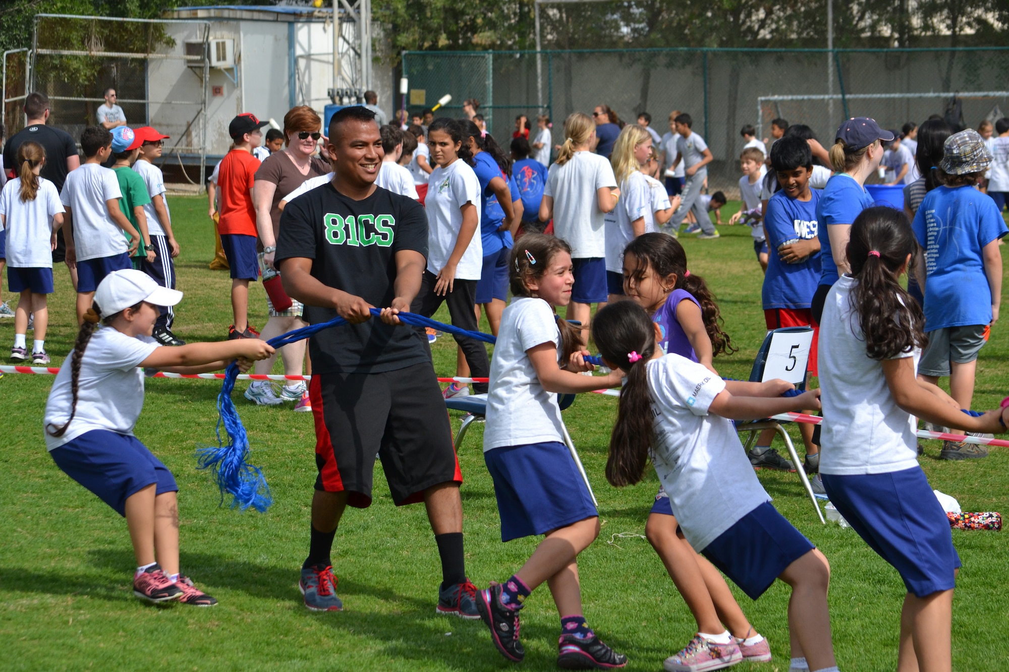 Senior Airman Henry Bones Pilligua participates in a game of tug of war with students from the American School of Doha in Qatar, during Sports Day, Feb. 2, 2014. Established in 2011, the Qatar National Sports Day prompted a government mandate that all schools develop a “sports day” the week prior to the national holiday to create awareness about sports and its health benefits in an effort to meet the challenges of a rapidly increasing youthful population. This year Qatar National Sports Day takes place Feb. 11. Bones Pilligua is assigned to the 379th Expeditionary Communications Squadron at Al Udeid Air Base, Qatar, and a Yonkers, N.Y., native deployed from Keesler Air Force Base, Miss. (U.S. Air Force photo/Maj. Nicole David)