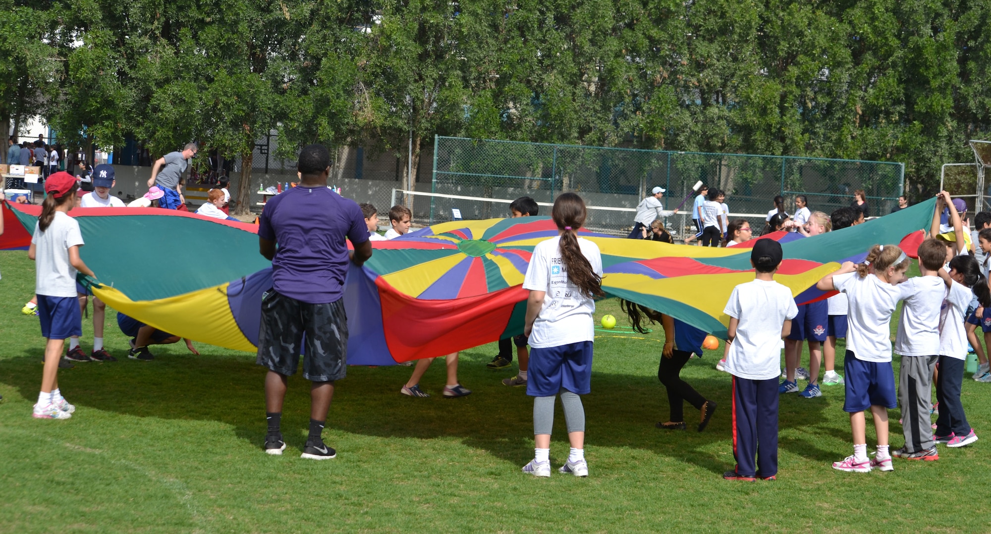 A total of 57 Airmen and Soldiers volunteer to spend the day with 977 students from the American School of Doha in Qatar, during Sports Day, Feb. 2, 2014. Established in 2011, the Qatar National Sports Day prompted a government mandate that all schools develop a “sports day” the week prior to the national holiday to create awareness about sports and its health benefits in an effort to meet the challenges of a rapidly increasing youthful population. This year Qatar National Sports Day takes place Feb. 11. (U.S. Air Force photo/Maj. Nicole David)