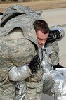 Senior Airman Christopher Horoho, 8th Civil Engineer Squadron firefighter, carries an exercise role player to safety during exercise Beverly Midnight 14-01 at Kunsan Air Base, Republic of Korea, Feb. 7, 2014. The Wolf Pack responded to a mass casualty situation caused by a simulated bus explosion on the flight line. (U.S. Air Force photo by Staff Sgt. Jessica Haas/Released)