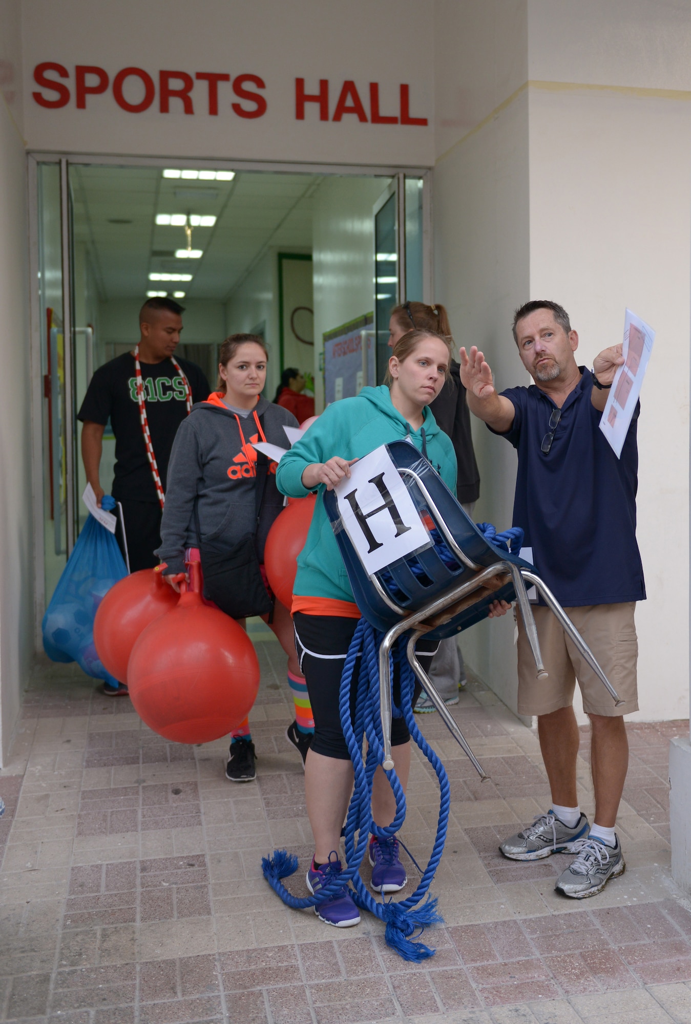 Volunteer service members set up different games for Sports day at the American School of Doha in Qatar, for Sports Day, Feb. 2, 2014. Established in 2011, the Qatar National Sports Day prompted a government mandate that all schools develop a “sports day” the week prior to the national holiday to create awareness about sports and its health benefits in an effort to meet the challenges of a rapidly increasing youthful population. This year Qatar National Sports Day takes place Feb. 11. (U.S. Air Force photo/Senior Airman Hannah Landeros)