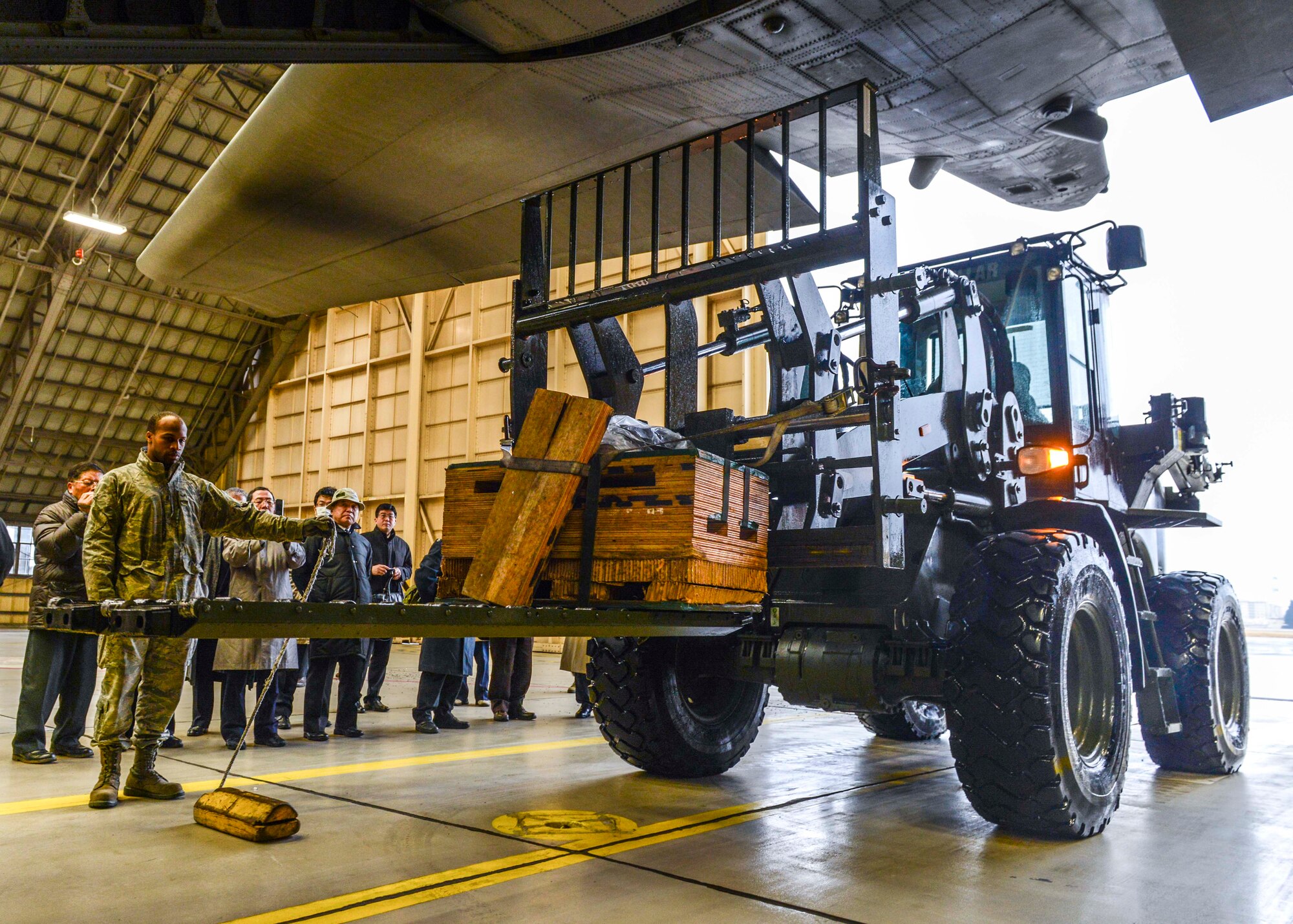 Yokota Airmen demonstrate loading Low-Cost, Low Altitude airdrop pallets to members of the Japan Society for Security and Crisis Management at Yokota Air Base, Japan, Feb. 4, 2014.  The LCLA is a cost-effective and reliable way to deliver humanitarian aid and disaster relief situation.  (U.S. Air Force photo by Airman 1st Class Soo C. Kim / released)