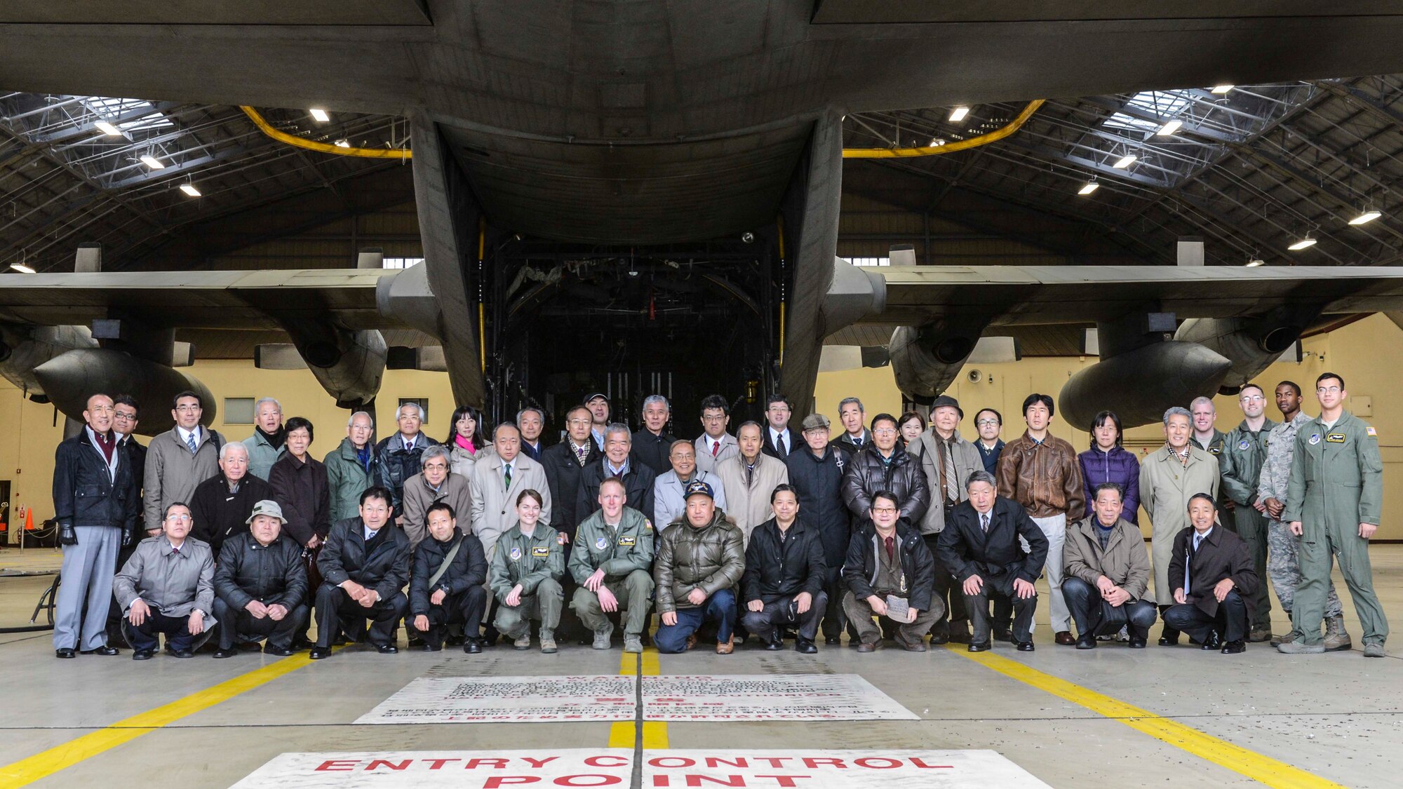 Yokota Airmen and members of the Japan Society for Security and Crisis Management pose for a group photo at Yokota Air Base, Japan, Feb. 4, 2014.  The Japan Society members visit Yokota to deepen the understanding of current status for security assurance between U.S. and Japan, as well as crisis management.  (U.S. Air Force photo by Airman 1st Class Soo C. Kim / released)