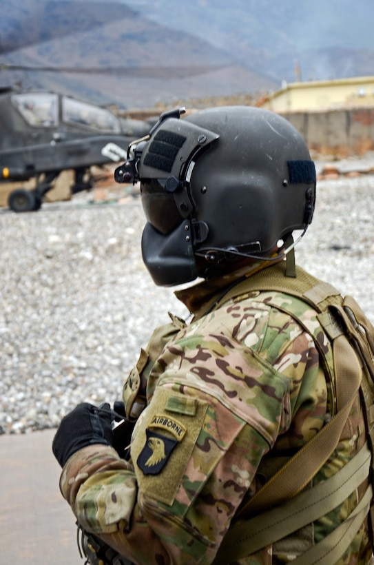 U.S. Army Spc. Adam Mehay stands outside a UH-60 Black Hawk helicopter during refueling on Forward Operating Base Fenty, Afghanistan, Feb. 3, 2014. Mehay, a crew chief, is assigned to the 101st Airborne Division's 159th Combat Aviation Brigade, Task Force Thunder.