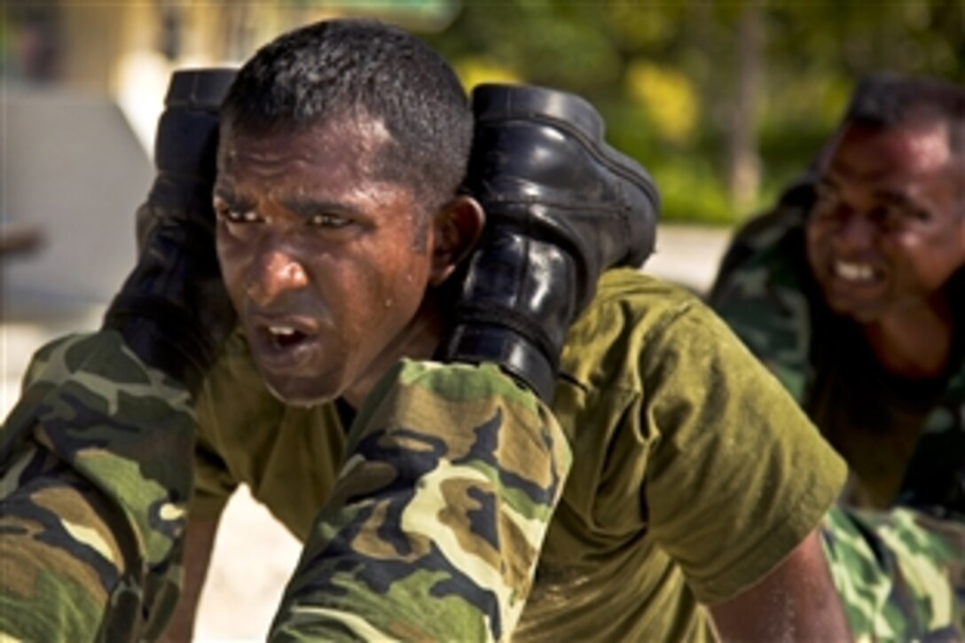 Maldivian marine Cpl. Mohamed Shakir takes part in squad push-ups during U.S. Marine Corps Martial Arts Program training with U.S. Marines on Maafilaafushi, Maldives, Feb. 3, 2014. This noncommissioned officer development program between U.S. and Maldivian Marines creates a setting for professional military and cultural exchanges. It also provides an opportunity for both forces to train in unfamiliar settings and gain experience with different tactics, techniques and procedures.