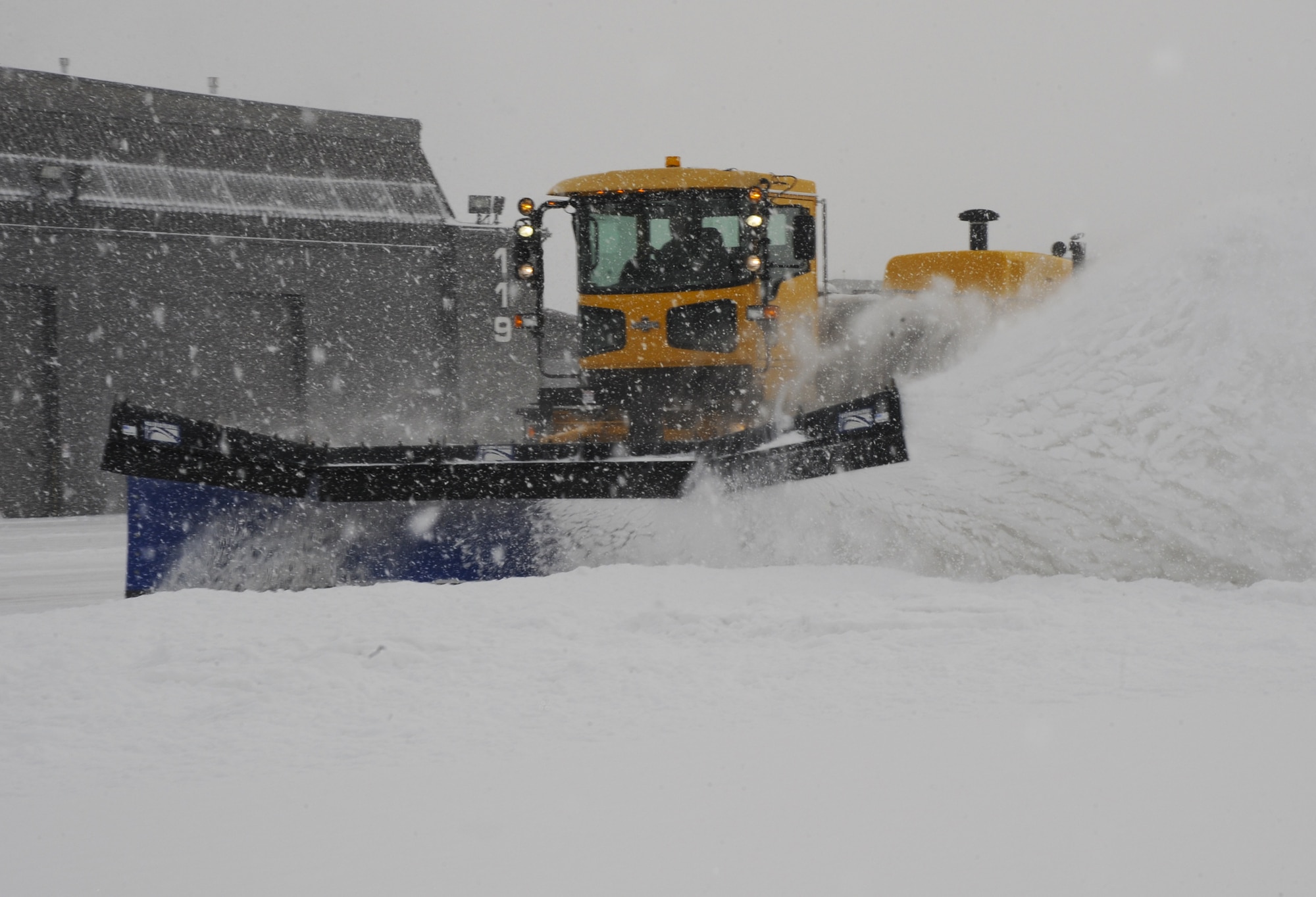 PETERSON AIR FORCE BASE, Colo. -- Staff Sgt. Matthew Cincotta, 21st Civil Engineer Squadron heavy equipment vehicle operator, uses a snow plow to remove snow from the flightline here Feb. 4. The 21st CES has four plows specifically for the flightline. Heavy equipment vehicle operators work in teams of three or four to clear the flightline as quickly as possible. (U.S. Air Force photo/Staff Sgt. Jacob Morgan)